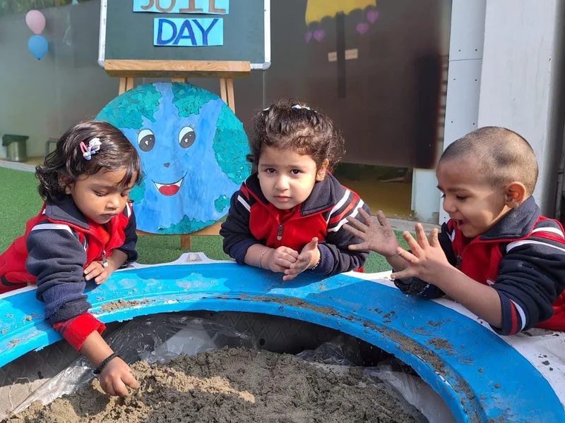 Pre Nursery children exploring textures during a sensory sand-play activity