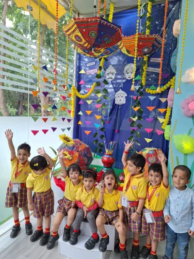 UKG children celebrating together in their school uniforms