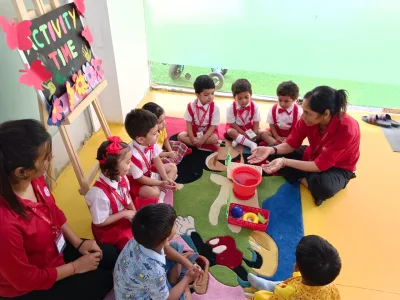 LKG children in a guided activity-time circle with their teacher