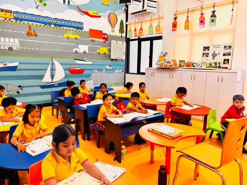 UKG children reading and writing at their desks in a cheerful classroom