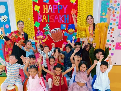 Two UKG teachers celebrating Baisakhi with their full class
