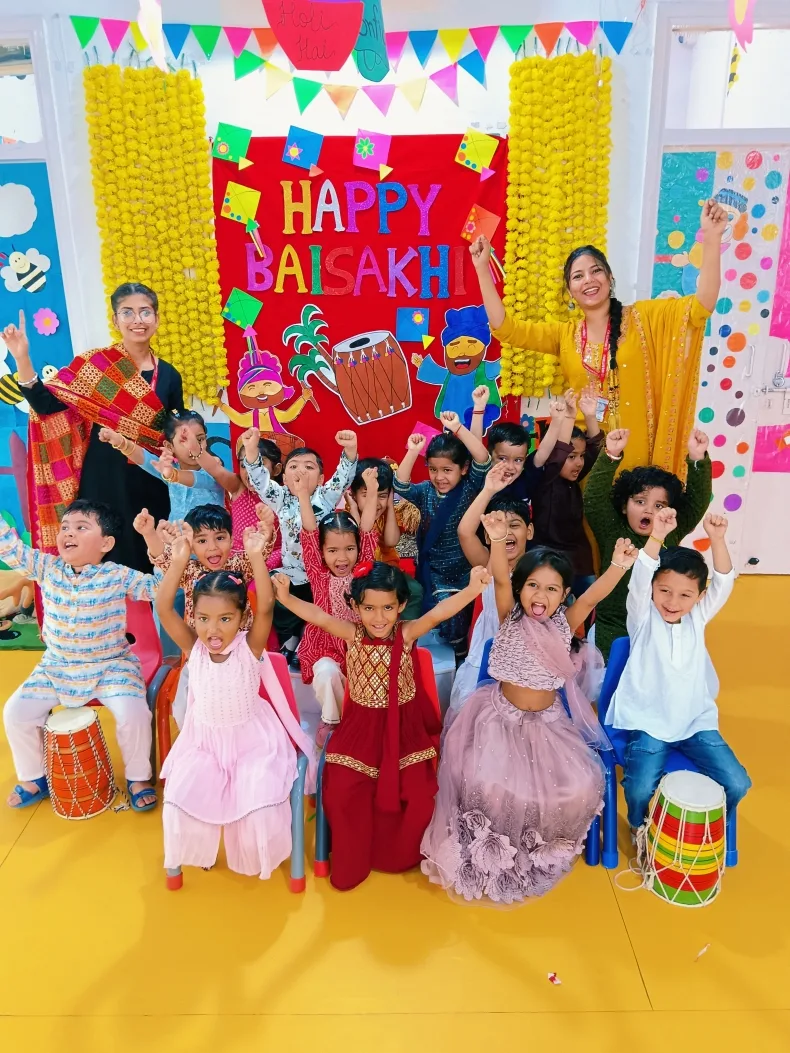 Children in traditional dress cheering for the Baisakhi celebration