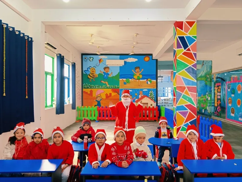 Children in Santa hats celebrating Christmas in the classroom