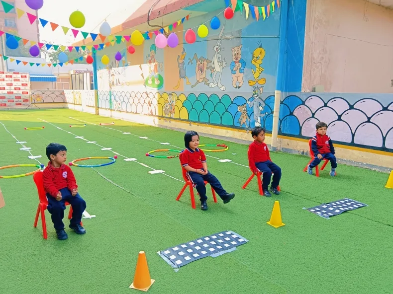 Children taking part in a hoop relay activity for National Sports Day