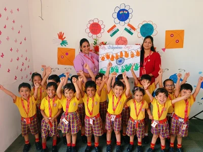 Two LKG teachers celebrating Independence Day with their full class