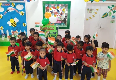 UKG children waving flags during a patriotic celebration